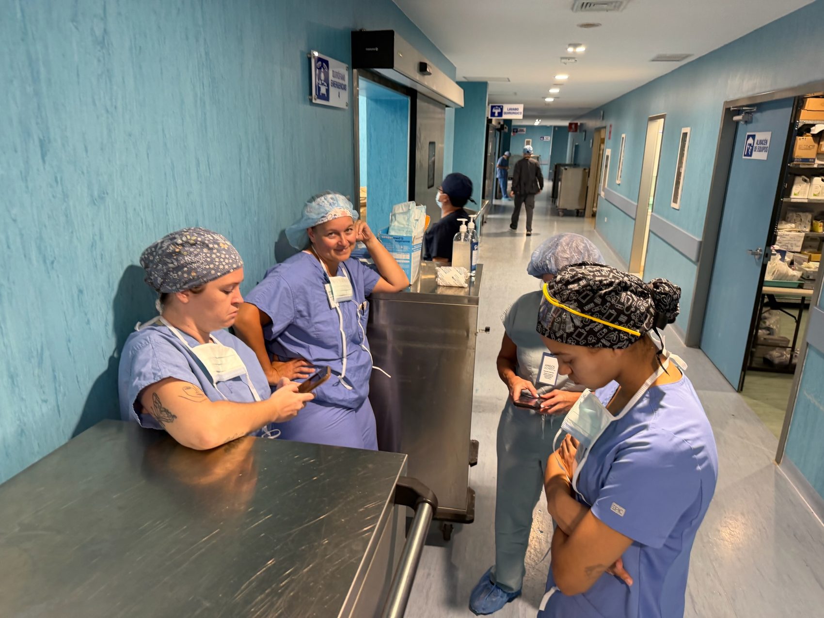 Hospital surgical corridor with signs for emergency operating rooms and surgical scrub