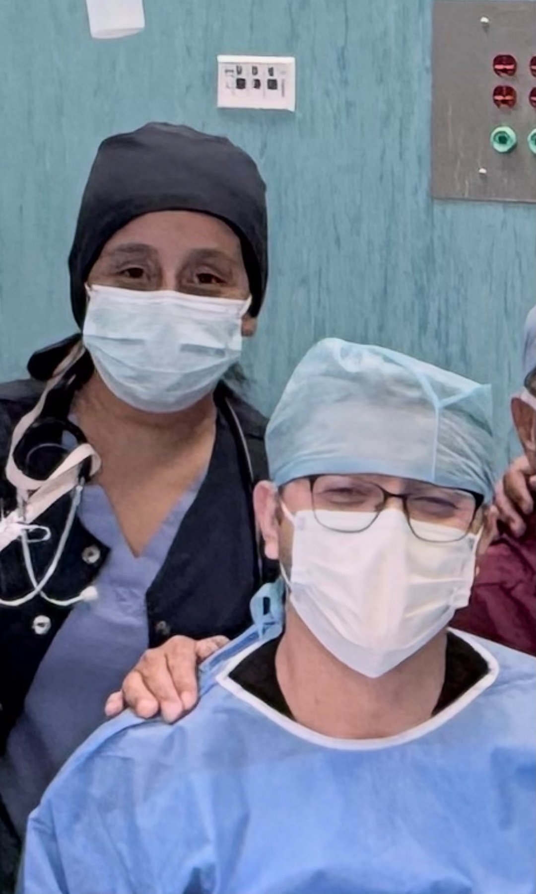 Dr. Tellez and Dr. Martinez, anesthesia and general surgery residents, in surgical attire